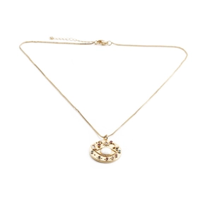 Detail of gold-plated eye pendant with a white stone and multicolor gems on a box chain
