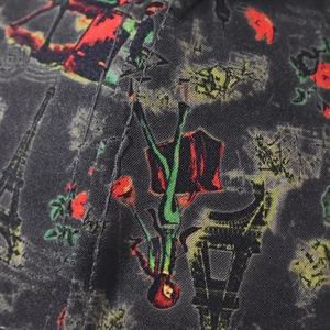 Detail of black fabric featuring Eiffel Tower and Little Prince prints with neat stitching