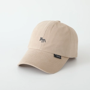 Close-up of fox embroidery and brand woven label on beige cotton kids baseball cap