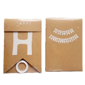 Kraft paper Happy Birthday banner set with gold stamped letters and white ribbons