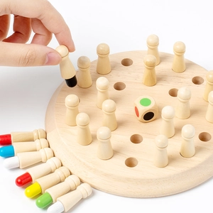 Close-up of hand picking a wooden memory chess piece with colorful bases on a round board