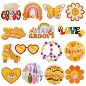 Set of 15 colorful retro bohemian iron-on embroidered patches with floral and peace motifs