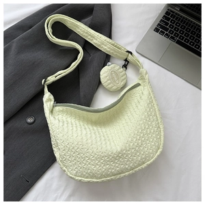 Detail of light green bubble texture crossbody bag with matching round coin purse