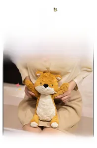 Close-up of a soft brown and white plush fox toy held by hands in a comforting scene