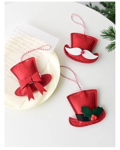 Three red felt Christmas hat ornaments with bow, beard and holly leaf details