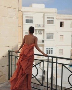 Detail of tiered ruffled backless maxi dress in burnt orange with delicate straps