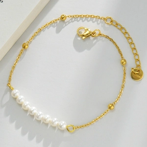 Detail of 14k gold-plated stainless steel bracelet with white pearls and S.Steel logo tag