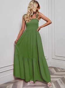 Detail of smocked elastic bust and shoulder straps on a green tiered maxi dress