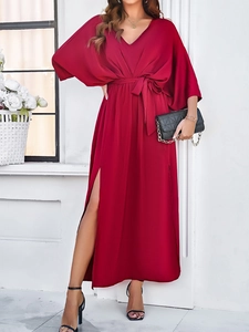 Detail of red V-neck maxi dress with batwing sleeves and side slit design
