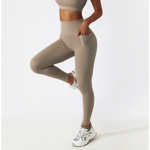 Detail view of high-waisted yoga leggings with side pockets in breathable khaki fabric