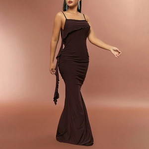 Detail of ruched texture and fringed hem on a chocolate brown backless maxi dress