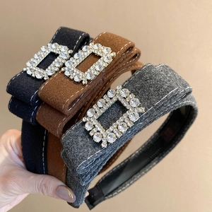 Detail view of flocked velvet headbands with sparkling rectangular rhinestone buckles