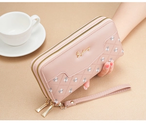 Pink quilted leather long wallet for women with double zippers and floral charm details