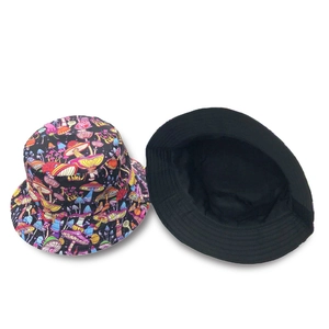 Close-up of reversible bucket hat featuring colorful mushroom prints and plain black lining