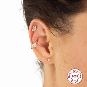 Three-piece set of 925 sterling silver gold earrings featuring studs and ear cuffs with gems