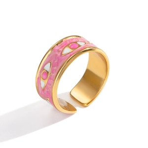 Macro detail of gold adjustable ring with pink enamel evil eye motif and polished finish