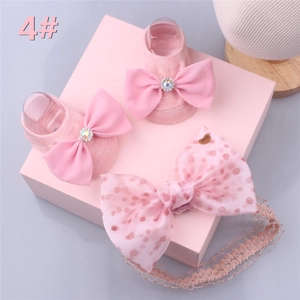 Pink baby socks and bow headband set featuring rhinestones and delicate lace details