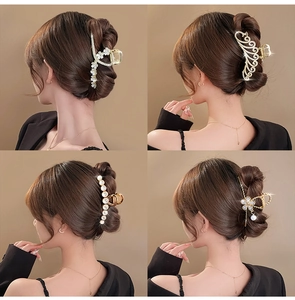 Elegant set of four large metal hair claw clips with pearls and rhinestones on hair bun