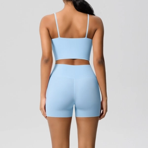 Women's sky blue yoga set featuring a strappy back sports bra and high-waisted shorts