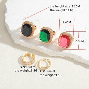 14K gold plated geometric rings with colorful gemstones and zircon on stone pedestal
