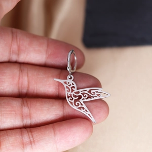 Polished stainless steel hummingbird hoop earrings with intricate filigree cutouts