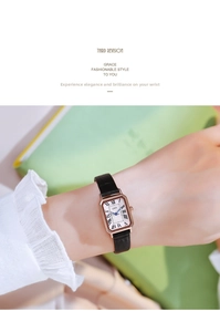 Detail of square quartz watch with Roman numerals and blue hands on leather strap