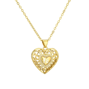 Detailed view of golden heart-shaped necklace featuring a carved interior with fe engraving
