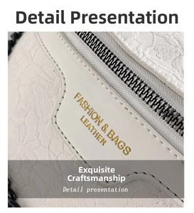 Macro detail of creamy white embossed leather with gold lettering and fine stitching