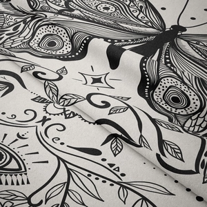 Detailed macro view of black and white bohemian tapestry featuring butterfly and mystic eye