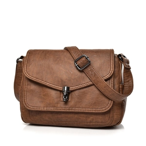 Brown vintage soft leather shoulder bag with textured finish and metal lock on white background