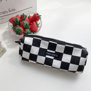 Checkered canvas pencil case with black and white grid and merci paris tag
