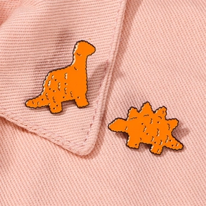 Cute orange dinosaur chicken nugget enamel pins set for children on pink fabric