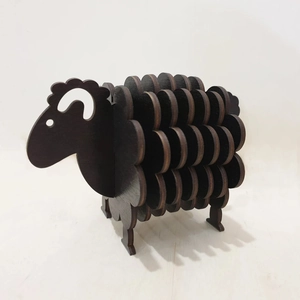 Macro side view of a dark brown wooden sheep-shaped coaster holder for table decor
