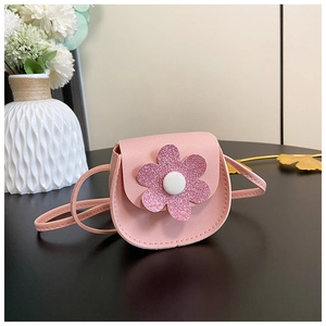 Detailed view of pink mini girl purse featuring a sparkling sequin flower and PU leather