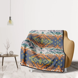 Detail of geometric ethnic pattern throw blanket on a modern yellow sofa in a minimal room