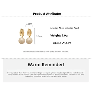 Detailed view of drop pearl earrings with golden textured metal, size 3.5cm x 1.5cm