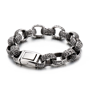 Retro punk men's stainless steel bracelet featuring embossed skull links in silver finish
