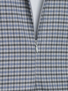 Close-up of the grey plaid fabric texture and seamless invisible zipper detail