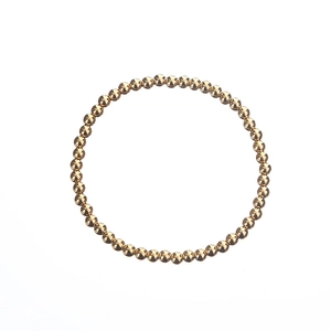 Detailed view of elastic gold beaded stainless steel bracelet with polished finish