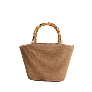 Straw woven handbag with bamboo handles and tan stripe texture for summer beach vacation