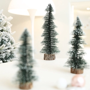 Miniature sisal Christmas tree with snow effect on a natural round wooden base