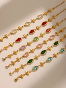 Detail view of heart-shaped gold-plated bracelets with colorful diamond-cut glass stones