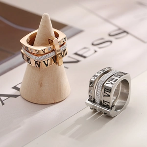 Macro view of Roman numeral engraved three-in-one rings with zircon inlay detail