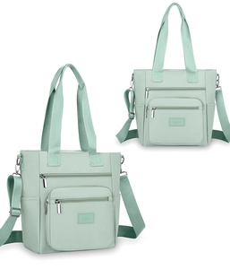Close-up of light green oxford nylon bag with multi-pocket design and adjustable strap
