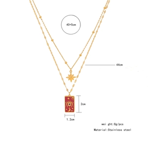 Detailed close-up of double-layer stainless steel gold necklace with celestial pendants