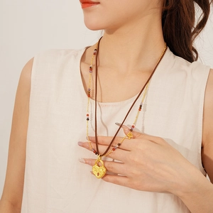 Double-layer necklace featuring heart lock pendant and brown leather cord on model