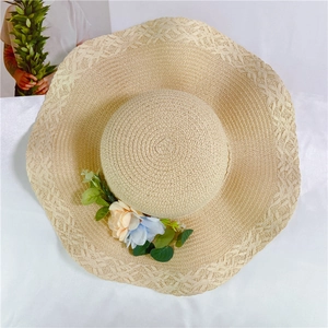 Beige woven straw sun hat with decorative floral accents and wide brim for beach outings