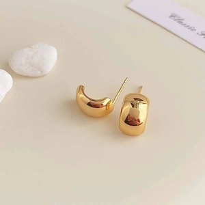 Close-up of minimalist 18K gold plated hoop earrings with a high-polished finish