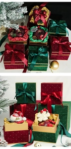 Close-up of velvet Christmas gift boxes with white dots and silky satin ribbons