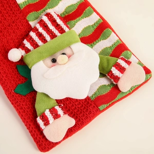 Christmas stocking with 3D Santa Claus doll in red and green knit for holiday gift packaging